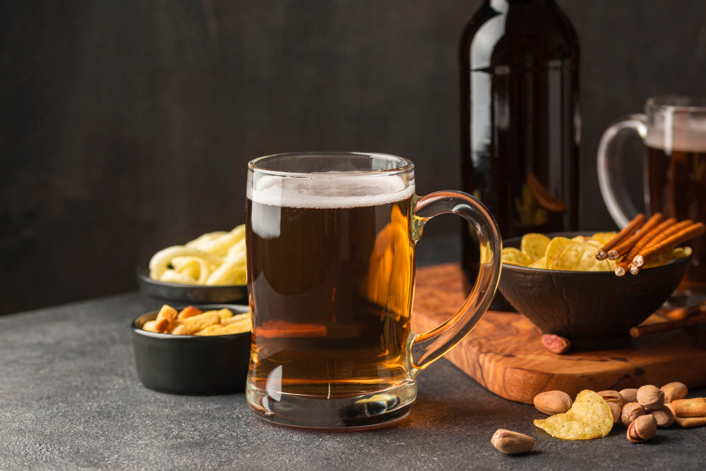 perfect pairings illustrated by a glass of alcohol of a with chips and other snacks on a table