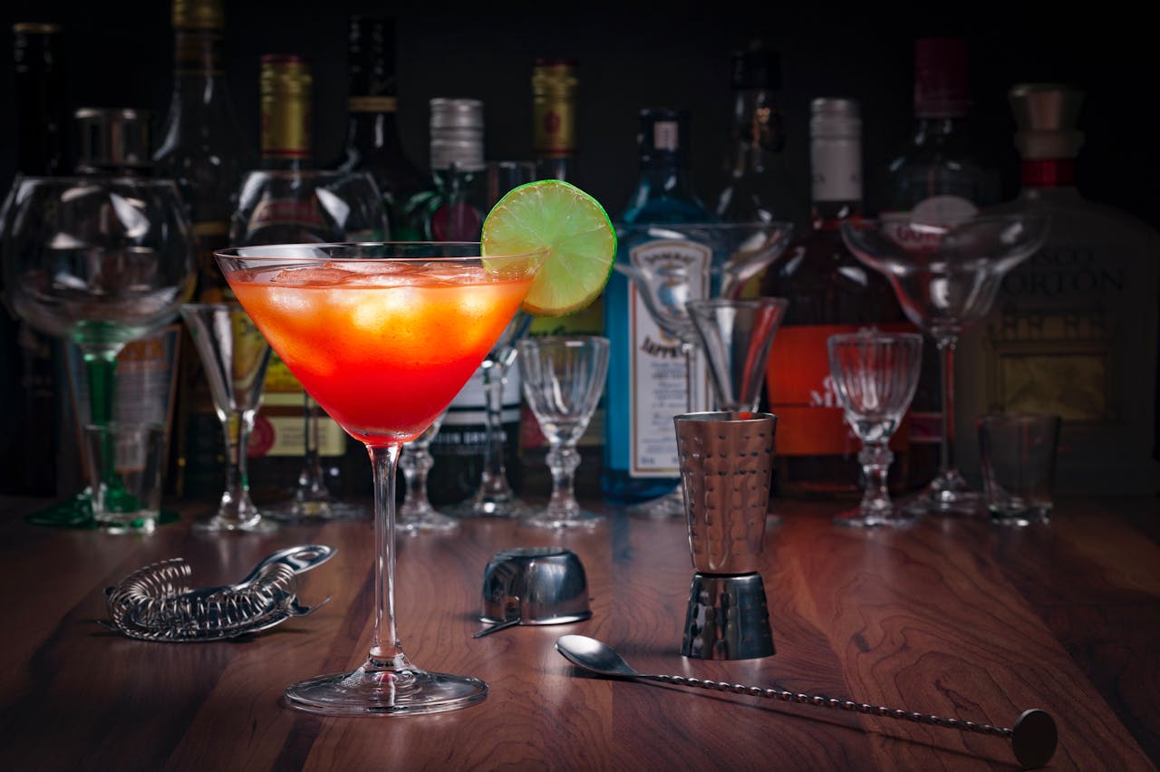 cocktail on bar counter with bar tools illustrating a clear spirits guide