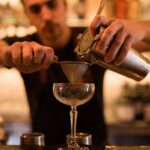 barman using Cocktail Chemistry to make a cocktail on the counter