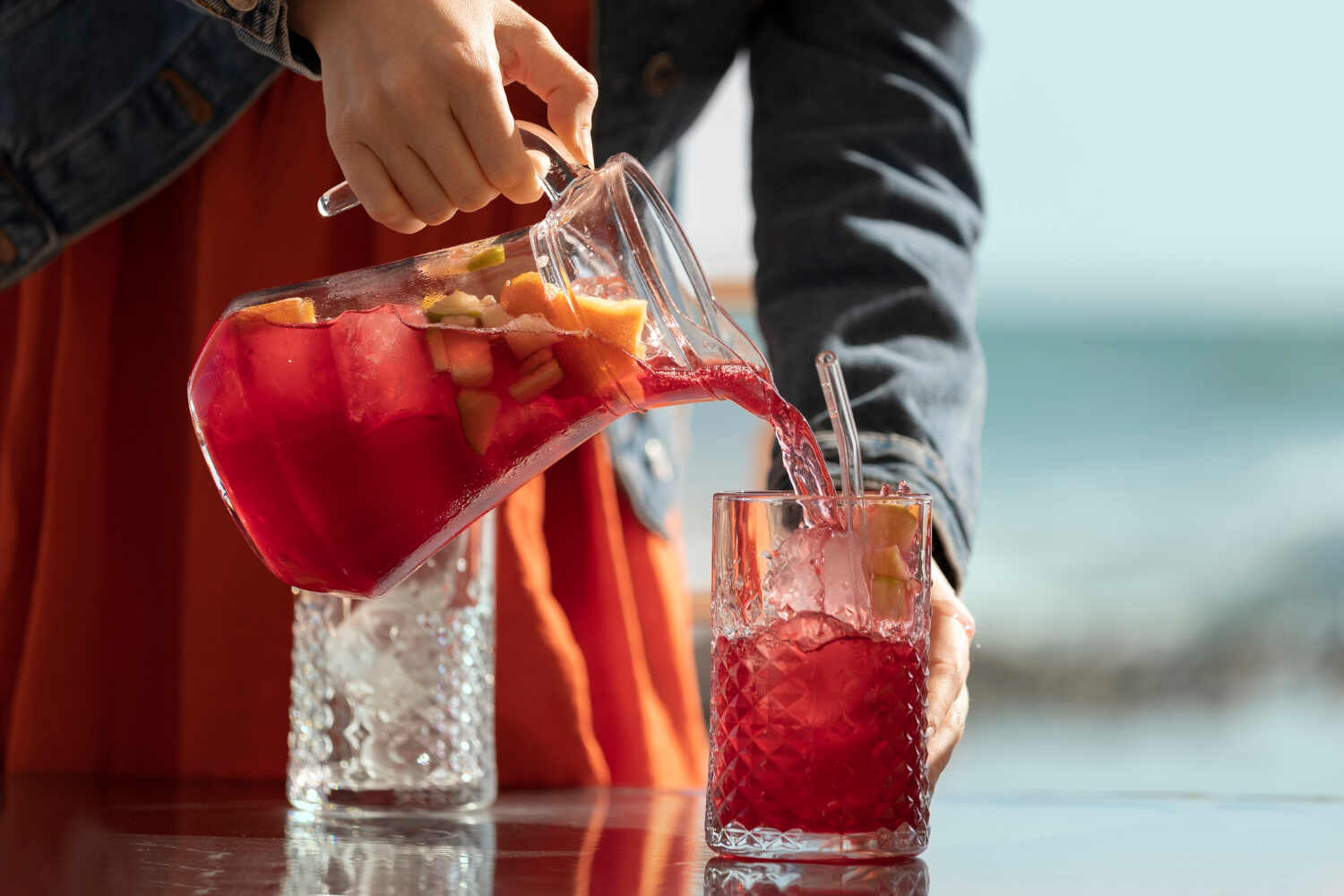 Sangria carafe being poured to illustrate Budget-Friendly Bar Hacks