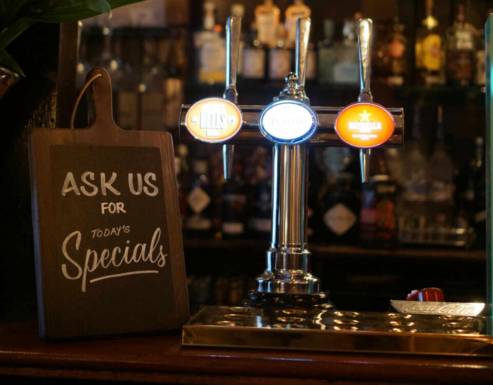 specials chalkboard at bar illustrating Budget-Friendly Bar Hacks