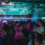 a disco themed bar filled with people as one of the top 10 theme nights