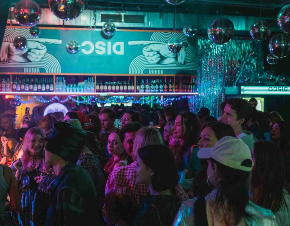 a disco themed bar filled with people as one of the top 10 theme nights