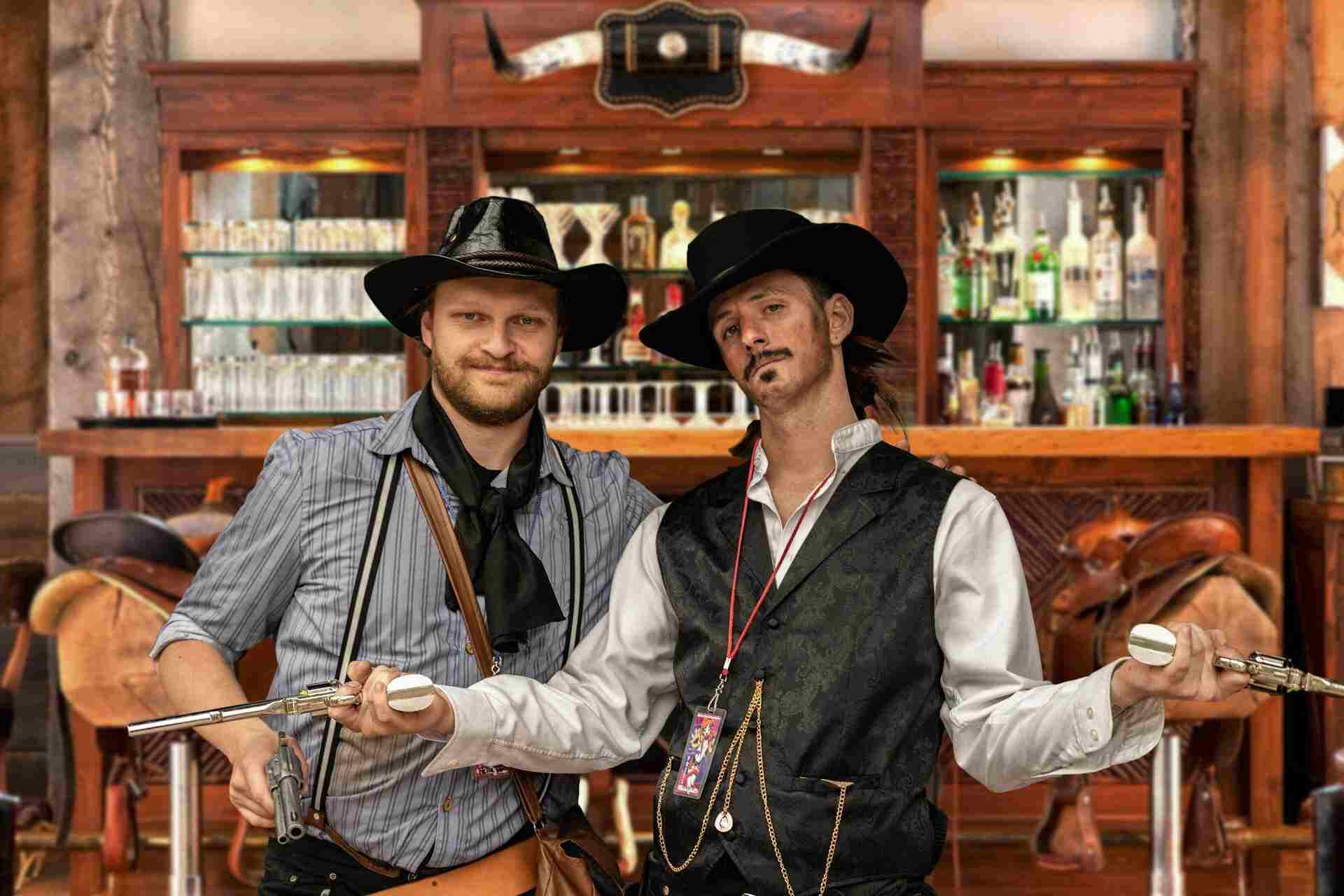 two men in front of a bar counter in cowboy outfits