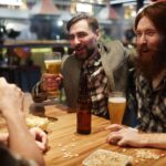 Regular patrons gathering inside a welcoming local pub, sharing stories and enjoying a comfortable social setting.