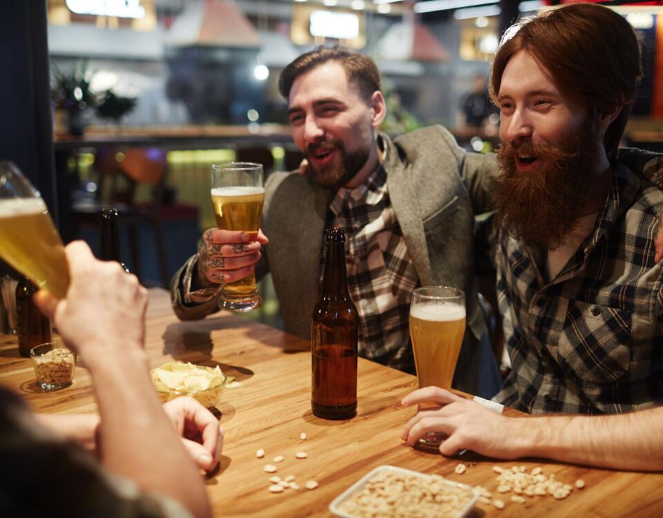Regular patrons gathering inside a welcoming local pub, sharing stories and enjoying a comfortable social setting.