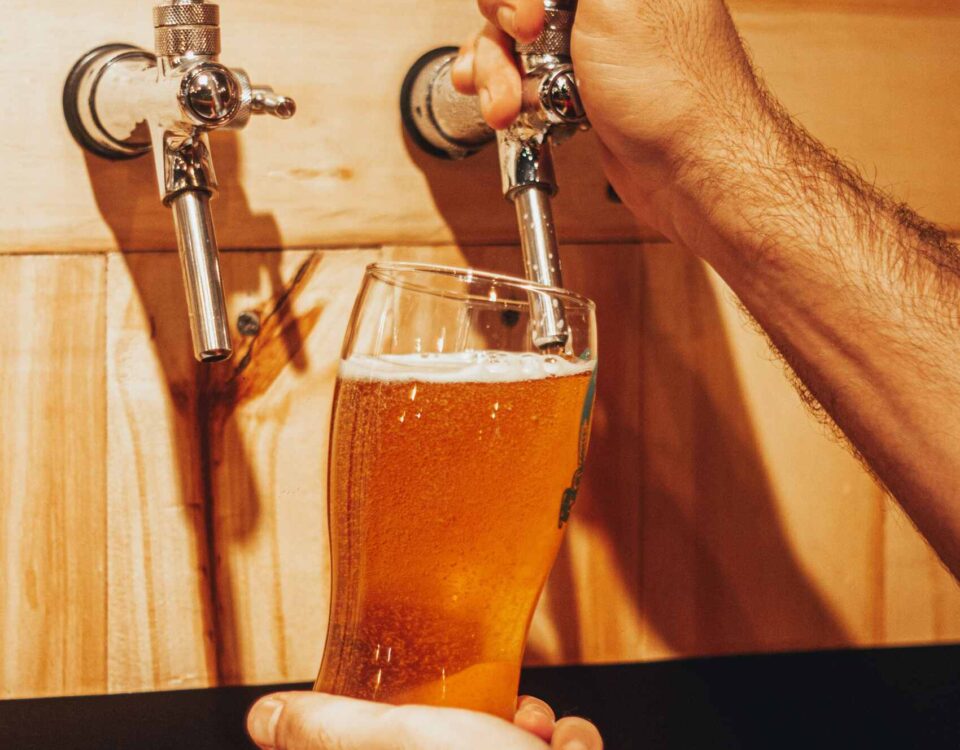 Beer taps pouring fresh draught beer behind the bar at The Highway Pub