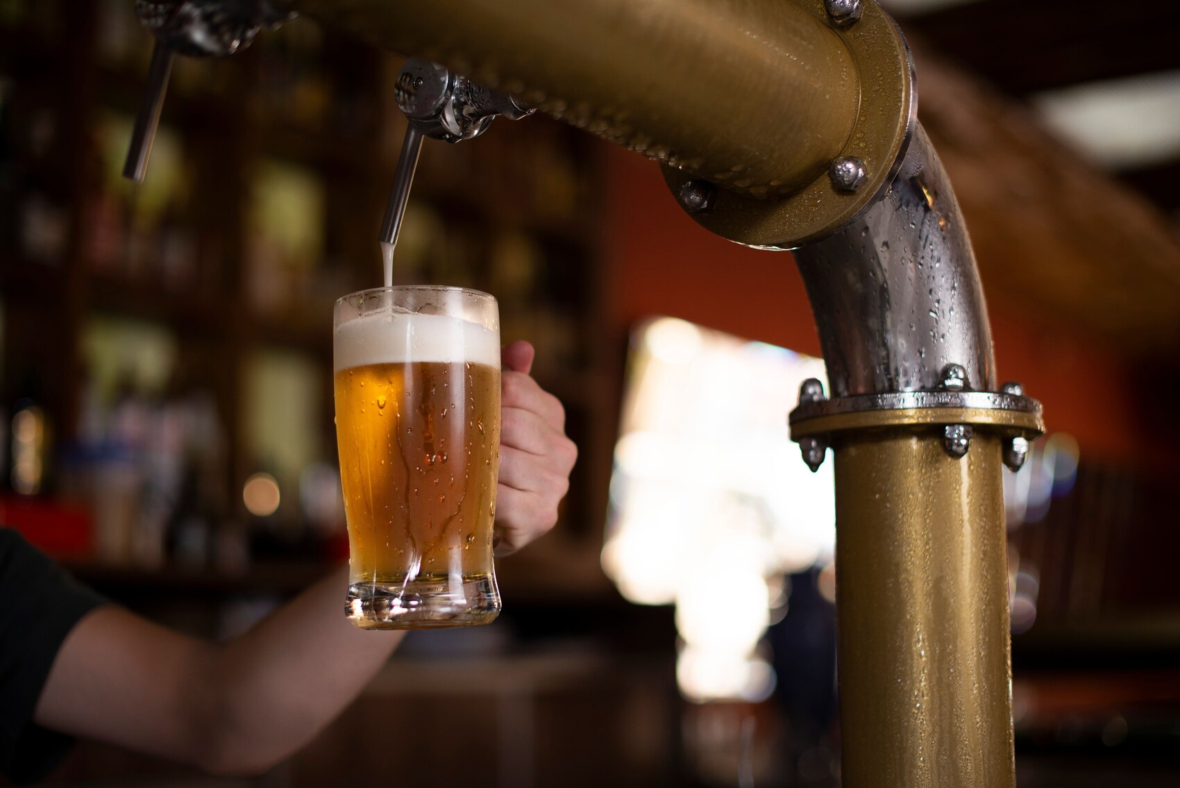 Beer taps pouring fresh draught beer behind the bar at The Highway Pub