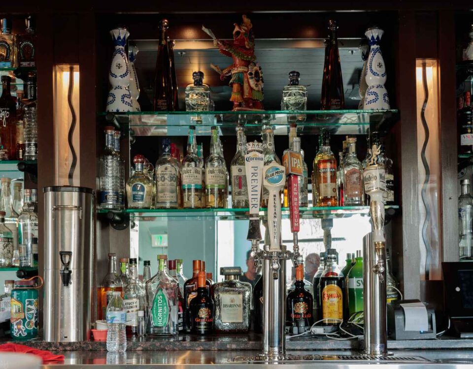 Traditional wooden bar counter with modern draught beer taps at The Highway Pub